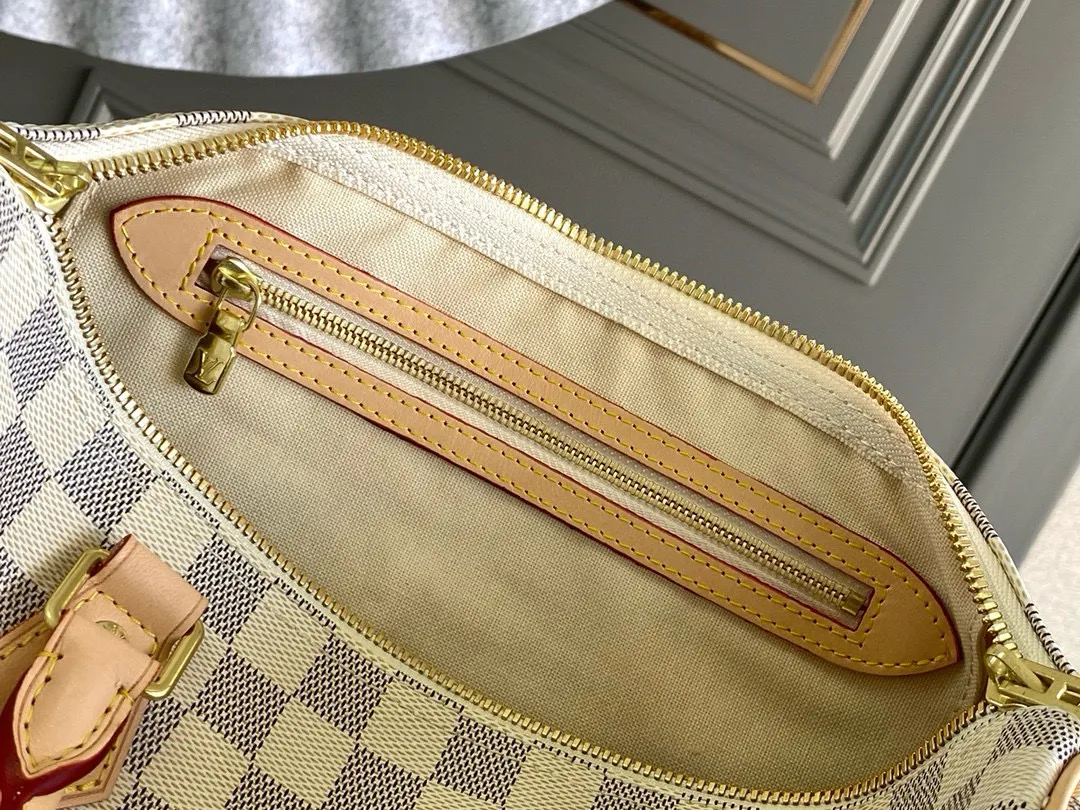 💰800 Top original N41373 SPEEDY 30 handbag (with shoulder strap) Every feature of this Speedy handbag is classic: leather handle, Damier Azur canvas. No wonder it has become a particularly popular bag in the world. Originally designed for travelers in 1930 (its name pays homage to the high-speed traffic of the time), the Speedy 30, with its cross-body strap, has become the ideal urban bag - soft, lightweight and classic. Detailed Features 30 x 21 x 17 cm (Length x Height x Width) Shiny gold-tone brass hardware and padlock Lockable double zipper closure Internal pocket D-ring for keys and accessories Soft fabric lining Shoulder strap: removable, adjustable Strap half-length: 48.0 cm Strap half-length adjustable to: 55.0 cm Handle: Double handle