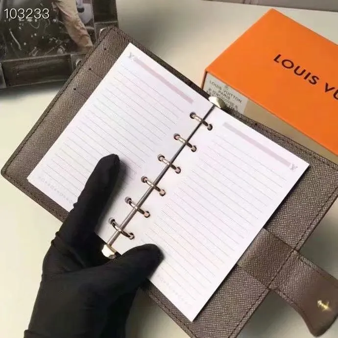 P140 Hot item shipped, model number M20005. This small notepad cover is made of Monogram canvas. It can hold three credit cards and can also be used as an address book, notebook or calendar. 10/12 cm (Length x Height) - Epi leather embossed with delicate LV initials and lined with interwoven textured leather - Button closure - Six-ring binder with three rings in sets, six credit card slots and two internal compartments - Notepad insert available separately