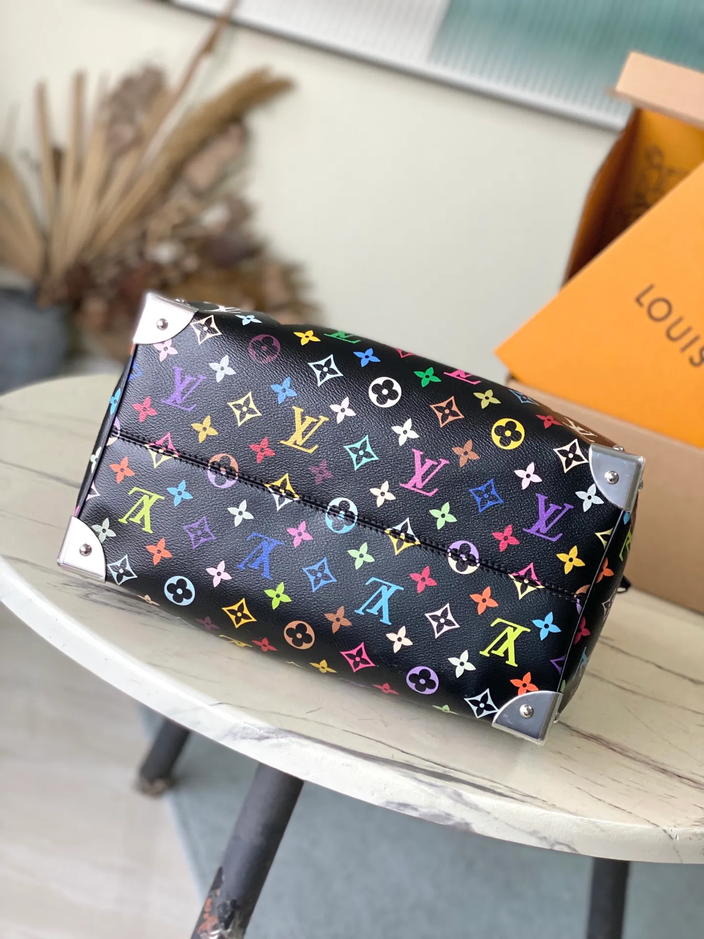 💰1180 Top Original M13257 This SpeedySoft30 handbag is made of soft coated canvas, and the full-length Monogram pattern is traced in colorful rainbow tones, highlighting the smart style of the Louis Vuitton x Murakami reissue series. The Toron handle and detachable shoulder strap are constructed of cow leather, the metal corners recall classic luggage elements, and the bow-shaped key bag and padlock add brand touches. Dimensions: 30 × 21 × 17 cm