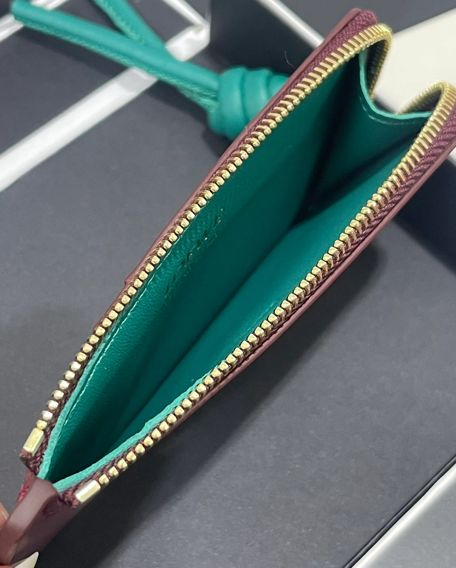 Satin nappa cowhide knot zipper small card holder, sheepskin lining, color-blocked knot pull tab, four card slots and zipper compartment. Style number 3793, size 13.5✕7 💰300