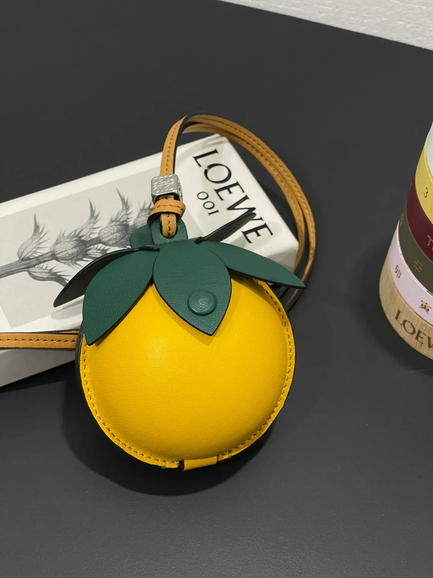 💰880 Passion fruit small bag pendant is made of calfskin with contrasting colors and fastened with snap buttons. It can hold some small items and change inside, and can be hung on the neck or bag.    Style No. 327 Size 12*11 (cards cannot be placed)