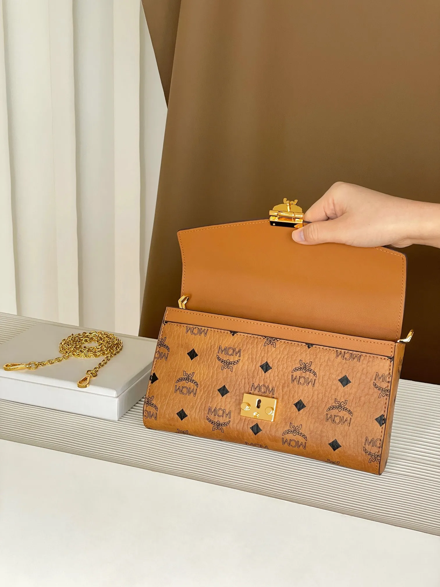 Upgraded version 💰460 with airplane case 𝐌𝐂𝐌 𝐓𝐫𝐚𝐜𝐲 𝐕𝐢𝐬𝐞𝐭𝐨𝐬 Medium pure chain envelope bag✉️ Exclusive®️Presbyopia printed all over This otherworldly Tracy crossbody bag is crafted from Italian Visetos and Nappa leather. This classic carry-on bag is accented with the signature bay leaf lock and features a lightweight, full-chain shoulder strap for effortless elegance.  Size: 23.5*5*13.5cm Shoulder strap: drop length 60cm/removable Closure: bay leaf lock Color: cognac/brown🏾