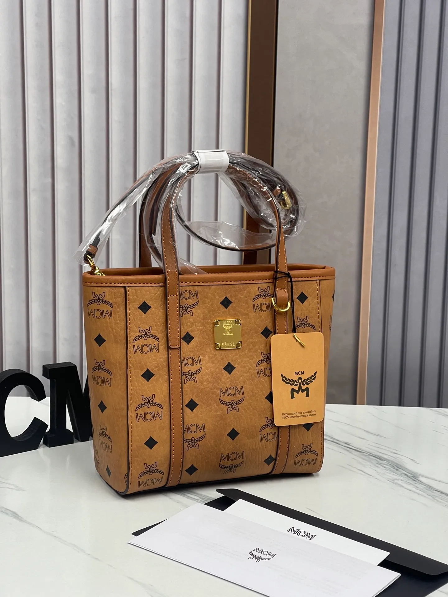 Batch 360💰🎋MCM new upgraded version·High quality✈️ Comes with environmentally friendly gift box♻️🎁Packaging model: 190820 Toni Visetos shopping bag has a new look, super beautiful👗 This compact shopping bag is multi-functional and will last forever. Don't let the size of this mini tote fool you, it's designed with spacious interior and exterior compartments to store all your small essentials. The cotton canvas lining features a print inspired by street fashion, subtly retaining MCM's adventurous aesthetic. Pair it with the included cross-body strap for hands-free functionality and greater portability. 18.5x19x9.5cm🌸