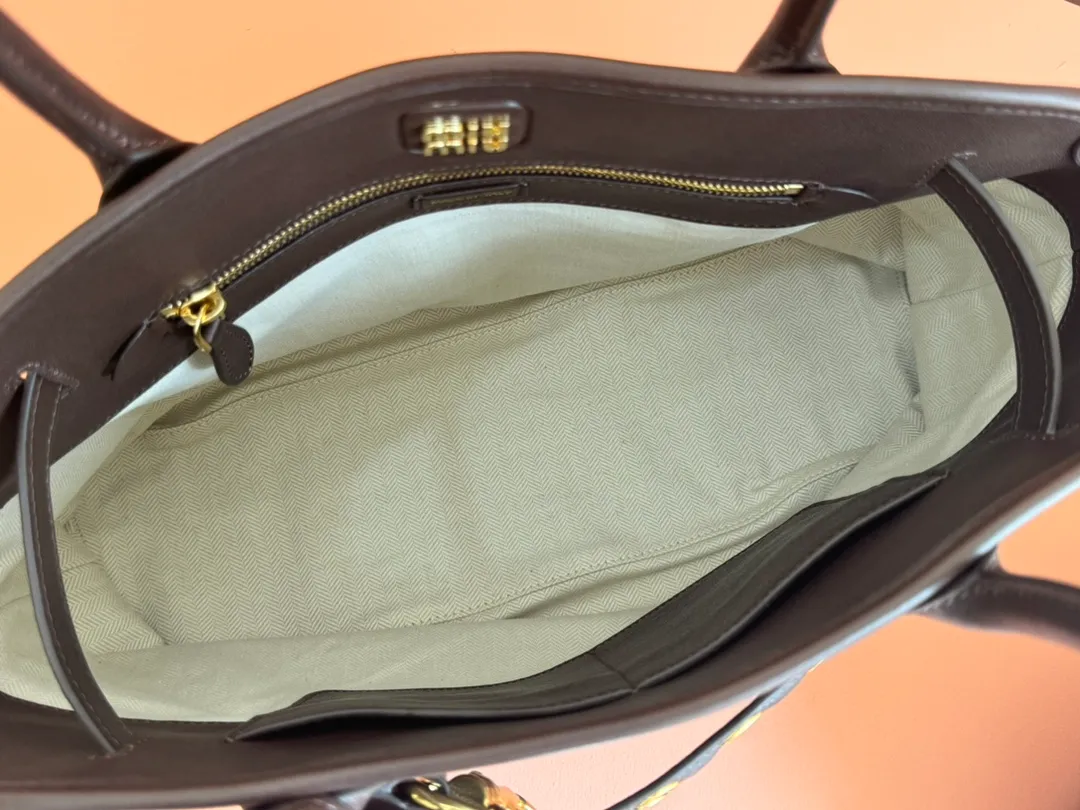 p2300💋💋💋Original leather Miu women's Nappa sheepskin handbag, inspired by the archive design, the structure has been adjusted to become lighter and rejuvenate with a new personality, creating a classic item with timeless charm. Decorated with an embossed monogram logo for an added signature touch 👝 Comes with handles for use as a tote or shoulder bag! Removable charm, antiqued gold-tone hardware, embossed lettering logo on front, lined interior, zip pocket and patch pocket! Size: 31✖️40✖️13cm Style number: 5BG291