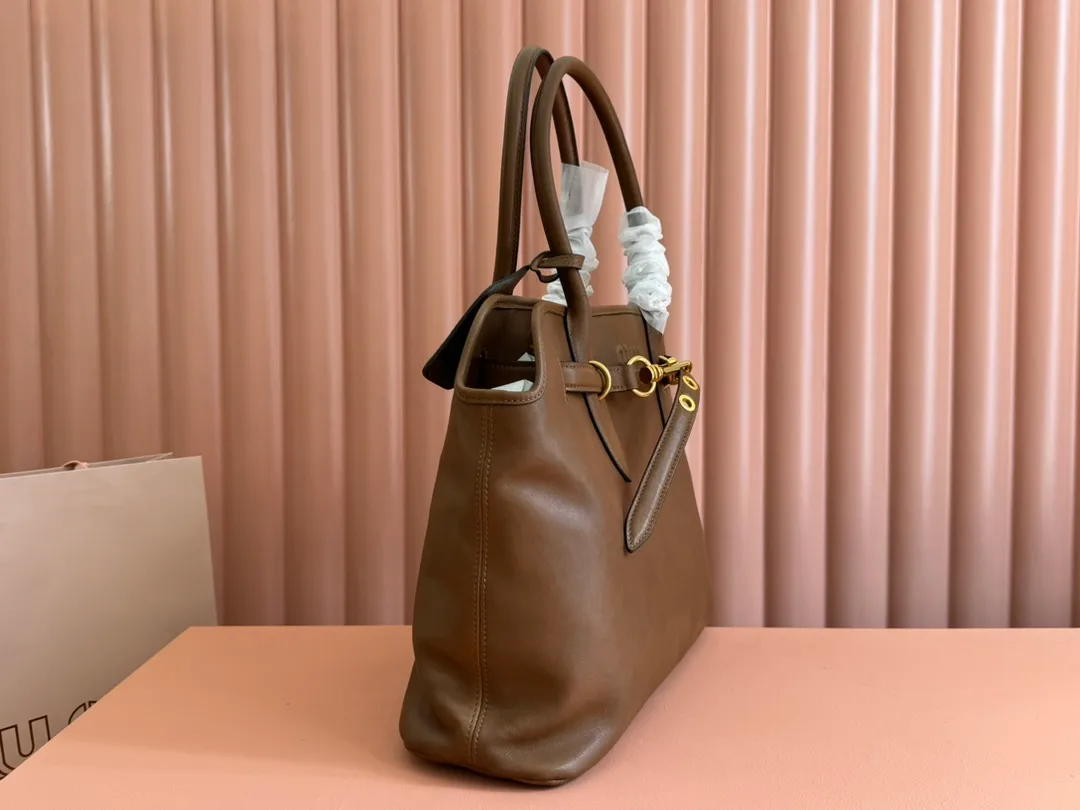p2300💋💋💋Original leather Miu women's Nappa sheepskin handbag, inspired by the archive design, the structure has been adjusted to become lighter and rejuvenate with a new personality, creating a classic item with timeless charm. Decorated with an embossed monogram logo for an added signature touch 👝 Comes with handles for use as a tote or shoulder bag! Removable charm, antiqued gold-tone hardware, embossed lettering logo on front, lined interior, zip pocket and patch pocket! Size: 31✖️40✖️13cm Style number: 5BG291