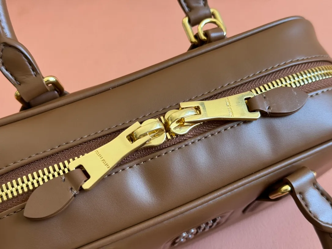 p1640💋💋💋【Full set of packaging at the counter】MIU MIU Miu Miu Caramel Bowling Upper Body Effect! Miu Miu Women's Arcadia Cowhide Handbag Crossbody Bag👝Lightly padded design makes the handbag look fuller, showing a cosmopolitan style. The letter logo, which echoes the finish of the metal hardware, straddles the line between function and decoration, giving this handbag a unique aesthetic and classic feel. Size: 22✖️10.5✖️7.5cm Style number: 5bb142 brown