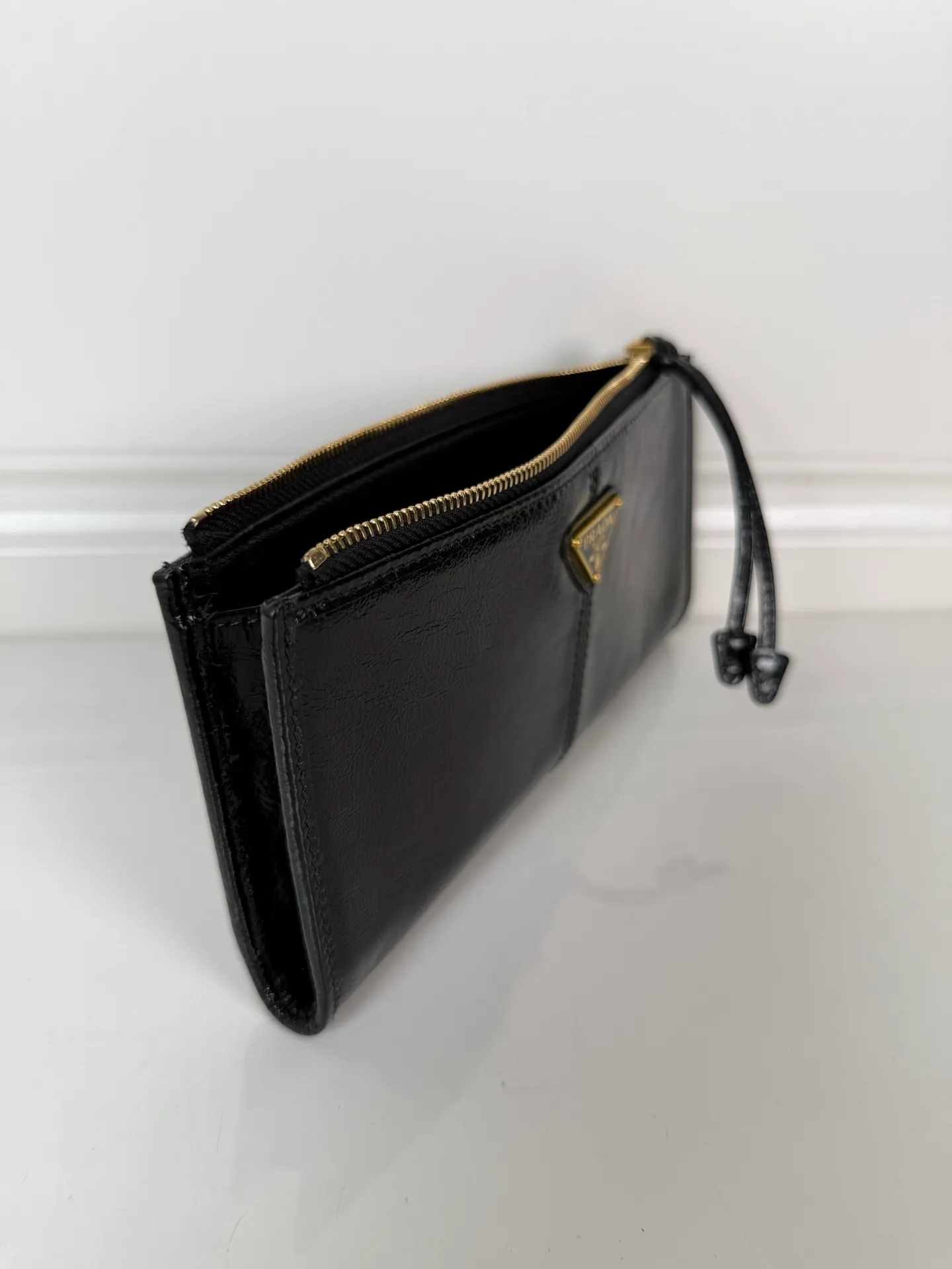 💰520, P Home ➡️Unisex pouch bag, this pouch is simple and exquisite, made of imported wax leather, with triangular metal logo and zipper closure. Model: 1MB051, size 20cm*10cm, 2 card slots, 1 leather lining