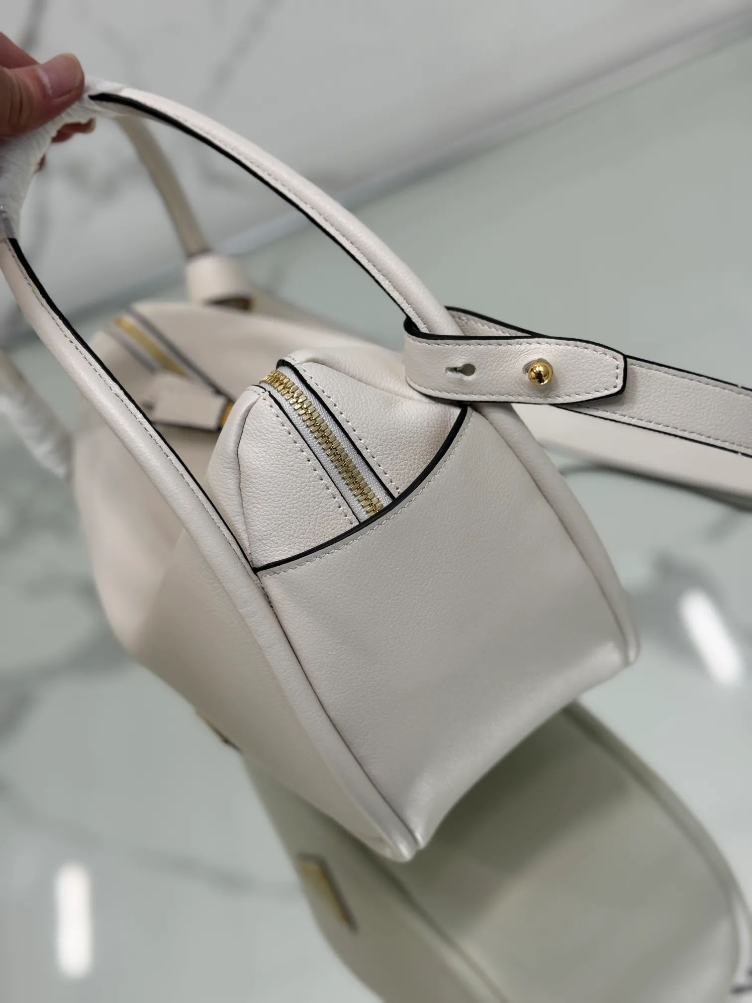 💰1500⭐ New bowling bag This Lindy handbag/shoulder bag is made of Italian Soft Grain imported calfskin, with top-grade hardware. The modern design highlights the casual attitude, and the exquisite details and metal hardware accessories add to the smartness. Sophisticated and versatile, the style is crafted from soft grained cowhide with smooth, minimal lines. Showcasing exceptional craftsmanship, this accessory is embellished with an enameled triangular metal logo. It can be carried by hand, shoulder, or cross-body. It has large capacity, is simple and practical, and has a great upper body😘 ●Double handles, 13 cm drop length ●Detachable shoulder strap, 75 cm long ·Open side pockets·Metal hardware accessories ·Enameled triangular metal logo on the front ·Zipper closure ·Lined and patch pockets Style number: 1ba451 Size: 25*18*10.5cm