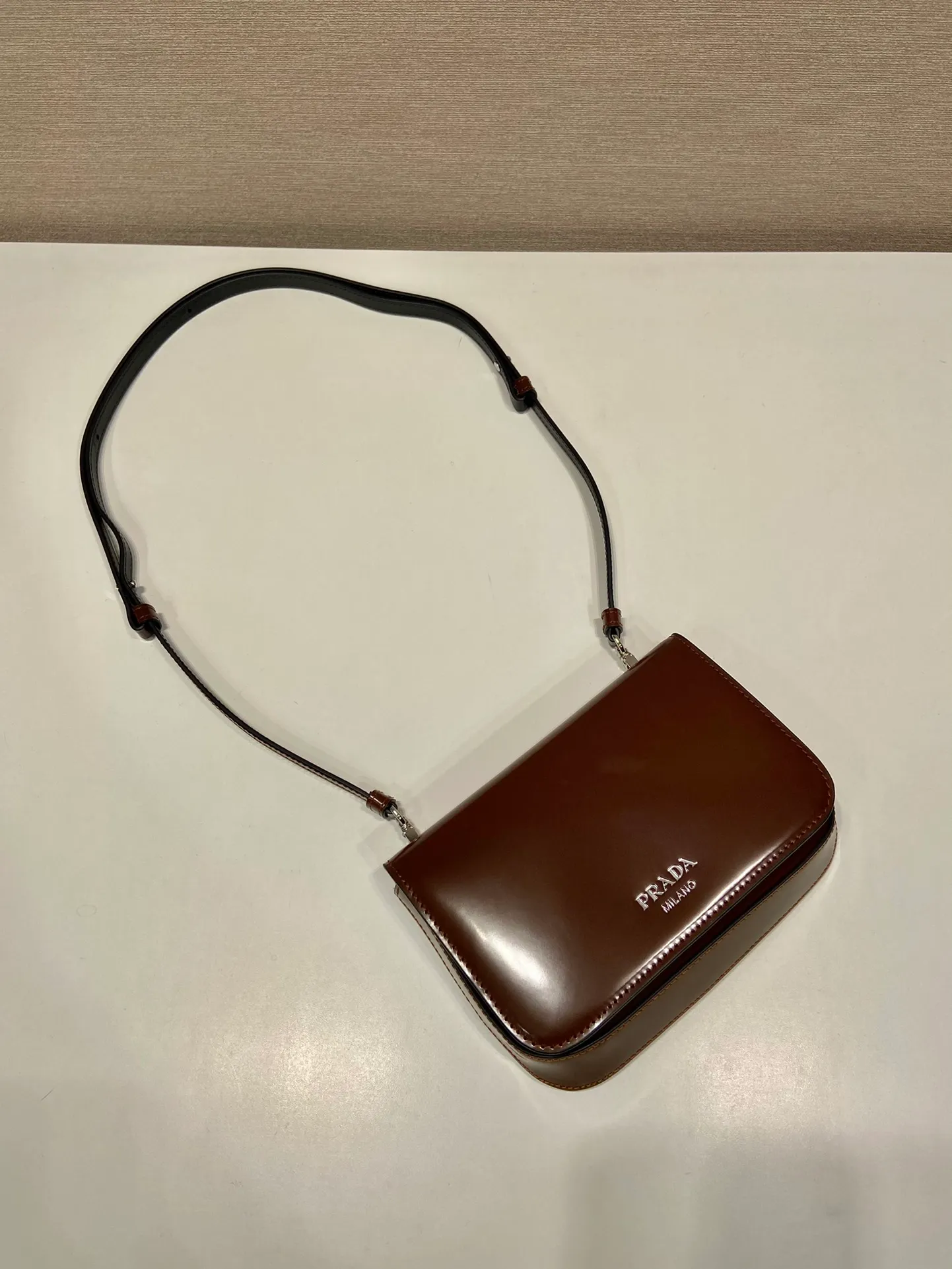 💰1100🎉New style🎉2VD061🎉2023 autumn and winter series fashion show🎉 This one is made of glossy leather. Can be worn around the neck. Signature sloping side construction creates a simple silhouette that sits flat against the body. Detachable and adjustable leather shoulder strap. Flap featuring heat-stamped logo. The upper body effect must be cool, it is suitable for both men and women, length 18x height 12.5x bottom 2.5cm