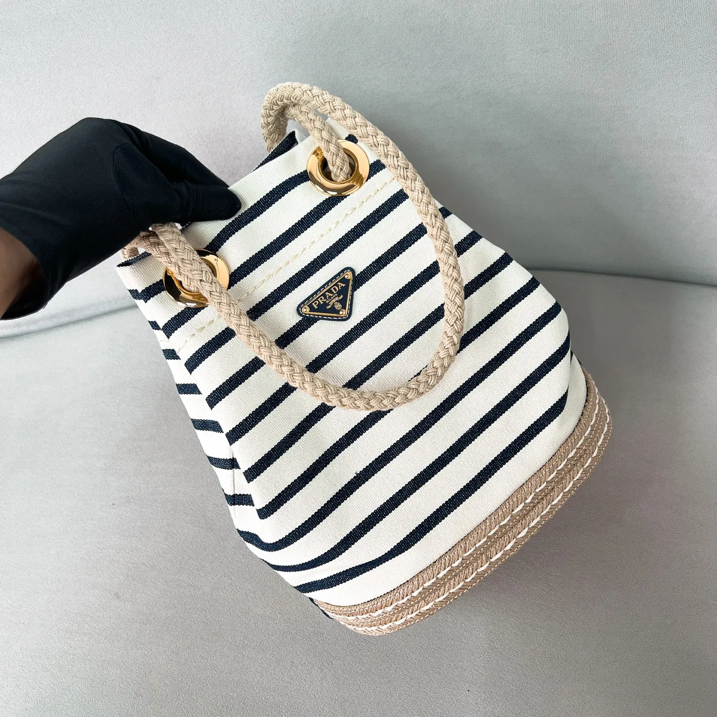 💰1160✨New product debut✨SS25 show new product Mariner canvas bucket bag 1BE082 Made of imported linen canvas fabric Nautical striped pattern Straw woven bottom highlights summer vacation style Sliding rope handle with classic golden triangle logo Drawstring buckle design Can adjust the space at will Lightweight can be packed and easy to match The randomness of different carrying methods and the ease of putting it anywhere Just pick it up and instantly transform into a pretty girl 🤩 Size: 28/23.5/16.5
