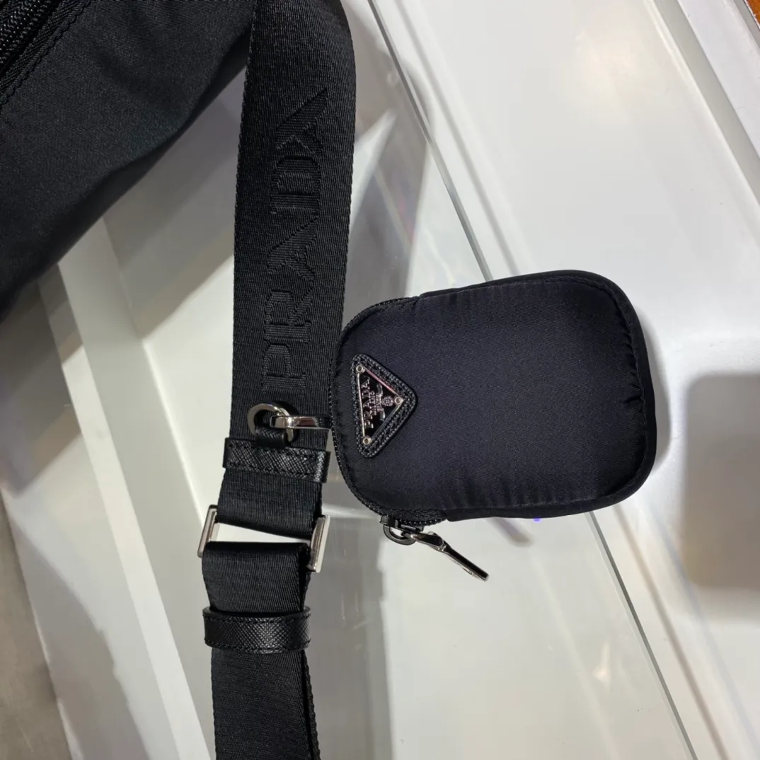 💰1260🎉Upgraded messenger bag🎉1BD671🎉🎉 This messenger bag is embellished with Saffiano leather details. Decorated with logo and steel hardware triangle elements, it is equipped with an adjustable fabric shoulder strap and a detachable small bag on the shoulder strap. I really love it😘😘The capacity is very large and the upper body effect is great. Get it now👏👏Another popular style that will never go out of style🎉🎉 Length 30x Height 25x Bottom 12cm🎉🎉🎉💰💰💰💰