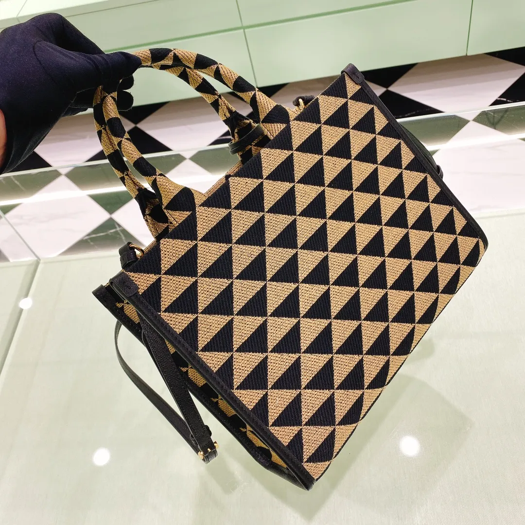💰1560✨New product debut✨🌟New product, new series embroidered triangle plaid tote bag 1BA354 medium size. The new fashion favorite tote bag that is popular all over the world. The bag is embroidered with triangular geometric patterns all over the body and imported cross-grain cowhide trim. The overall bag is simple, elegant and luxurious in texture. The golden triangle logo on the front is added with Saffiano cowhide name plate. It is equipped with a detachable full leather shoulder strap. It has a large capacity and is full of matching points. A must-have tote bag for little fairies, size 22*9*28cm