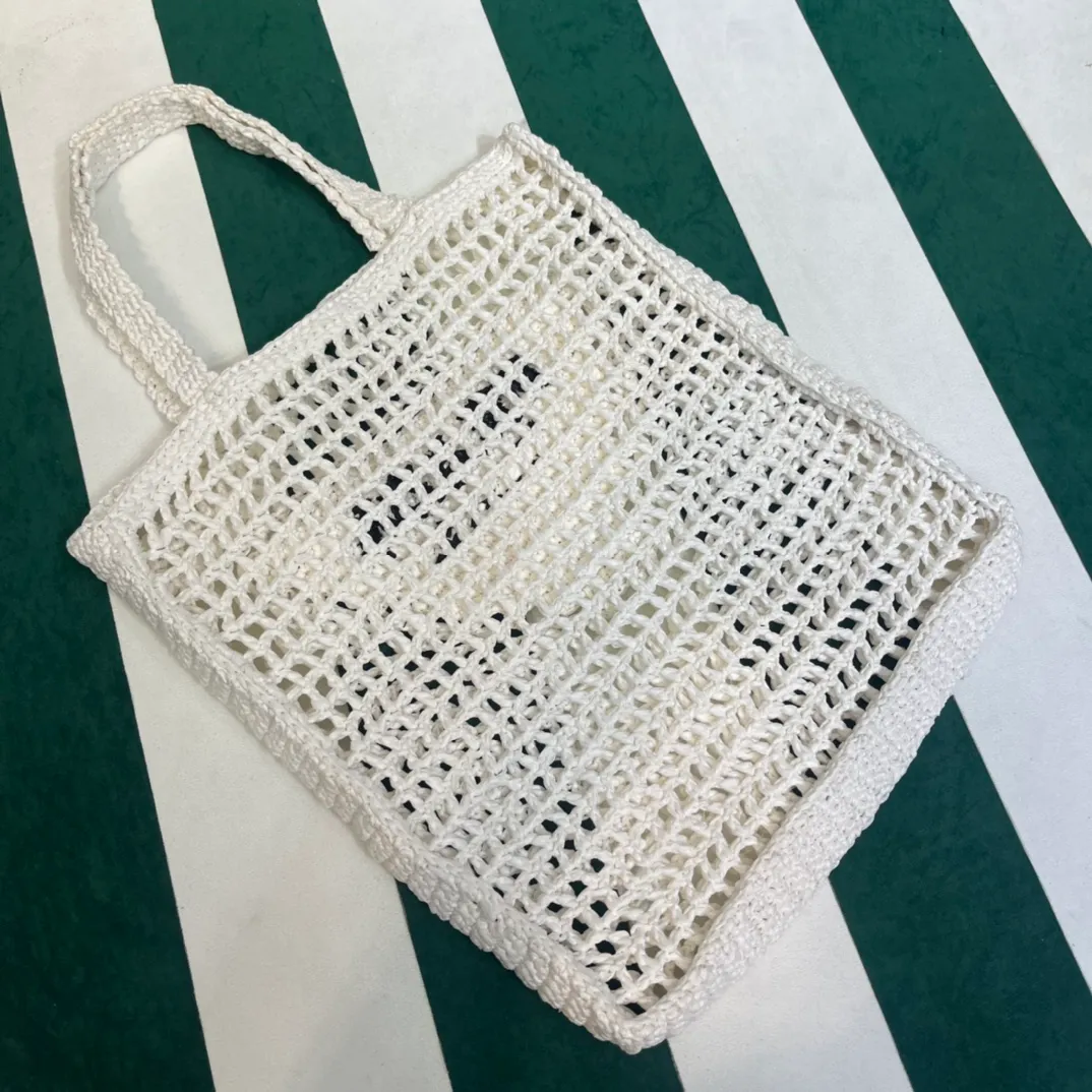 💰1160 Raffia Upgraded Version/White🦴 𝗣𝗿'𝗮𝗱𝗮Raffia Fiber Tote Bag Made of high-quality imported raffia🌿 Purely handmade! Every craftsman makes it with care and crochets it stitch by stitch! How can summer outings, picnics, and photo shoots be complete without a beautiful, lightweight and chic straw bag? 393 Size: 36×4×38cm