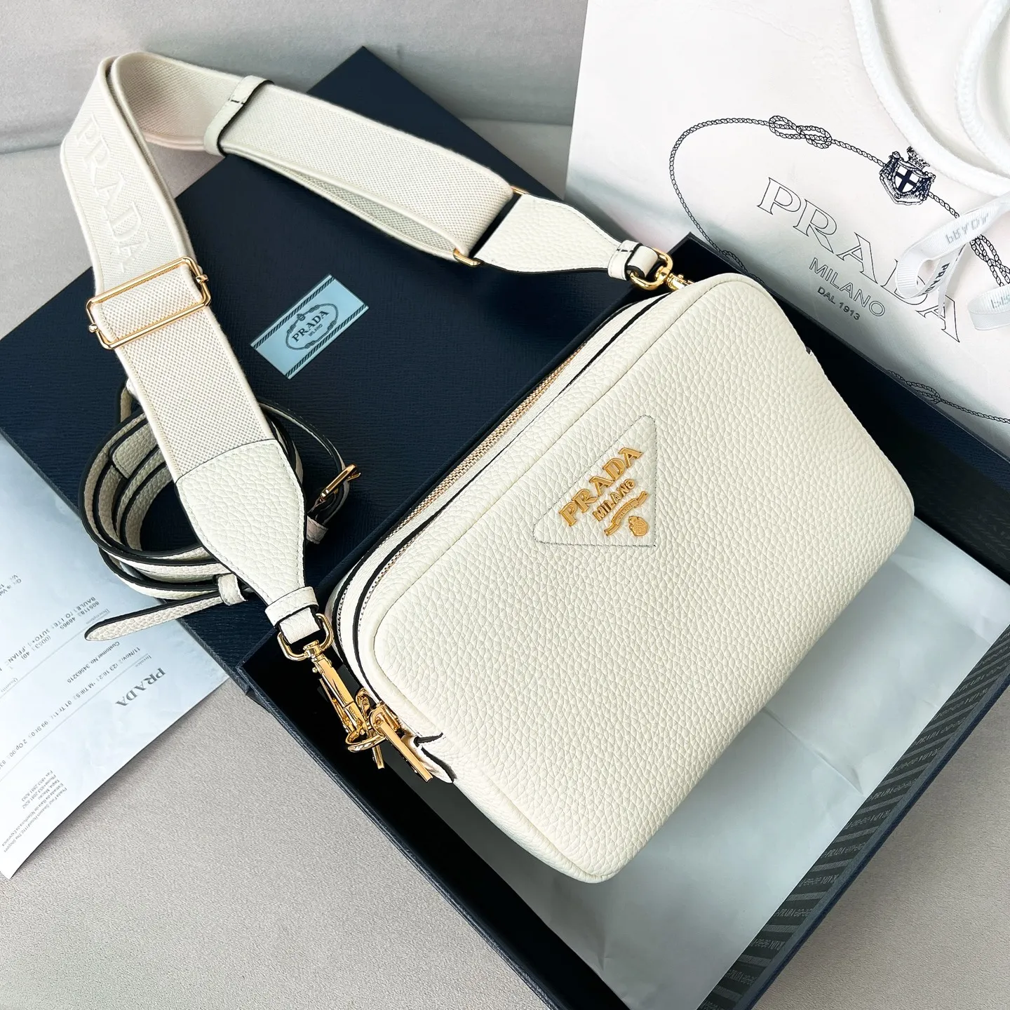 💰1700✨New product launch✨The latest pebbled shoulder bag with double zipper 1BH082 is carefully made of soft textured pebbled calfskin. The bag has a rounded and soft silhouette. Multi-functional detachable embroidered shoulder straps and leather shoulder straps. Double zipper compartments for more convenient storage. Outstanding and elegant style. Can be carried in hand, on one shoulder or crossbody. A handbag that perfectly blends classic heritage with the trend of the times. Fairy must-have white size 22*14.5*8.5cm