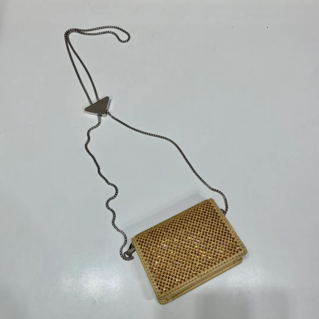 💰760🎉Necklace crystal pouch🎉1MR024 new color🎉🎉 This Duchesse fabric card holder is decorated with imitation crystals throughout, creating a light and shadow style and iridescent colors on the surface, highlighting a gorgeous yet functional design. My favorite is this detachable and adjustable iron shoulder strap, which can be used as a waist bag decoration😍😍 or as a necklace decoration with clothes. The triangle mark in the middle can be adjusted, giving the item a variety of ways to wear it. The space can be used to hold lipstick 💄/earphones/keys🚗....it bling bling under the night light, so beautiful. Worth buying 🎉🎉 Length 11.5x Height 8cm