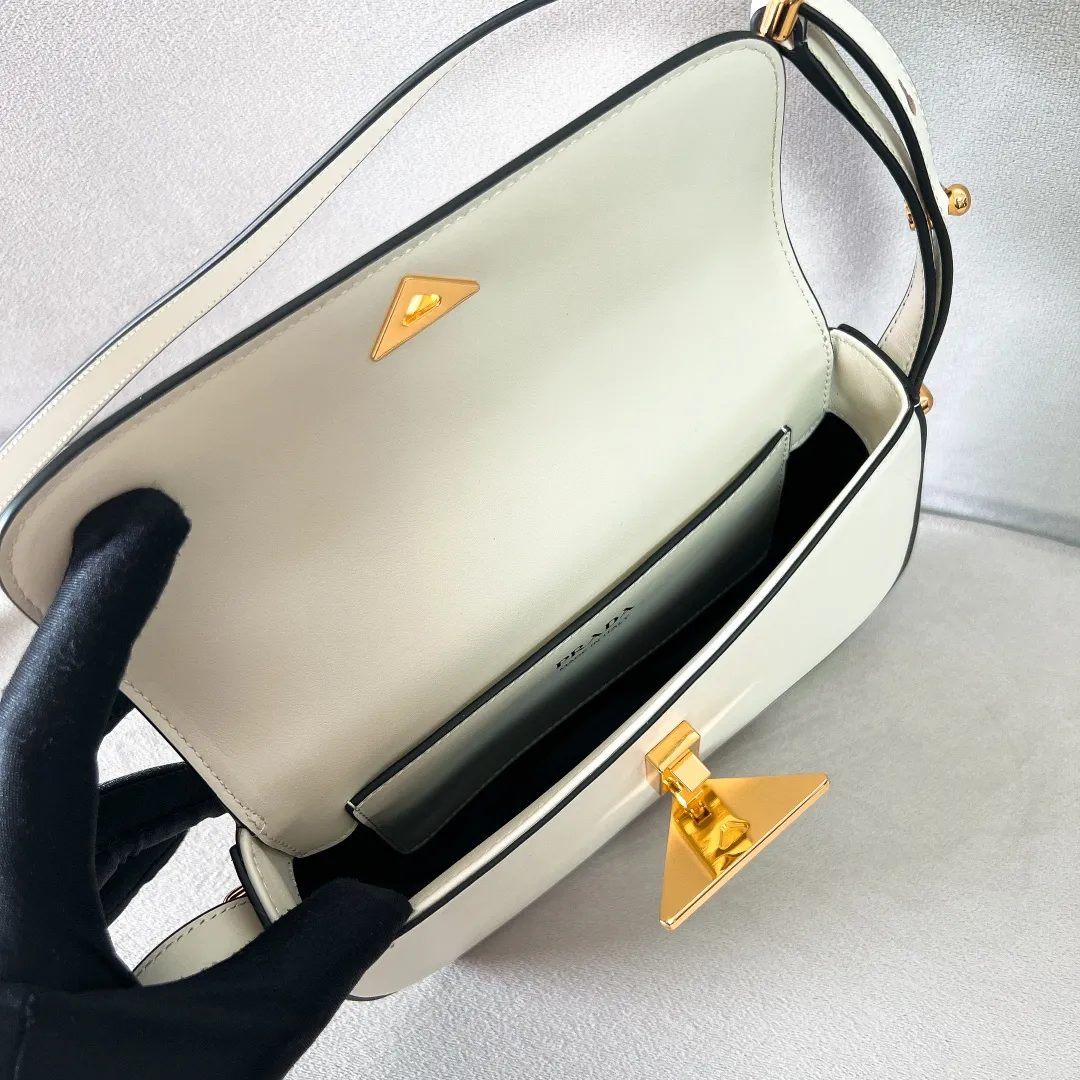 💰1440✨New product launch✨2023 new series shoulder bag 1BD339 is made of exquisite calfskin and is equipped with the iconic triangular logo decorative lock. The shoulder strap is adjustable and can be carried under the armpit or on one shoulder. The overall style of the bag is simple and the lines are elegant. Fashion and retro style are combined. The inner compartment capacity is also great. It is a new fashion trendsetter that combines retro fashion and practicality😘 Size 20.5*10.5*4 white