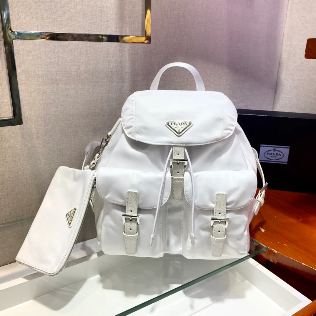 💰1120🎉New Backpack🎉1BZ811👍👍New Color🎉🎉This nylon backpack is trimmed with exquisite Saffiano leather, a blend of multiple materials, and decorated with a triangular logo, highlighting fashionable elegance. It also comes with a detachable small handbag😘😘Light and practical, the upper body effect is super stylish, and it can be matched at will😘😘Fully upgraded nylon fabric👍👍Length 30x Height 32x Bottom 15cm👏👏👏💰💰💰