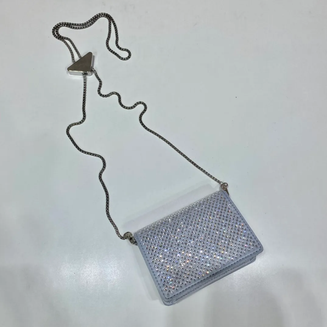 💰760🎉Necklace crystal pouch🎉1MR024 new color🎉🎉 This Duchesse fabric card holder is decorated with imitation crystals throughout, creating a light and shadow style and iridescent colors on the surface, highlighting a gorgeous yet functional design. My favorite is this detachable and adjustable iron shoulder strap, which can be used as a waist bag decoration😍😍 or as a necklace decoration with clothes. The triangle mark in the middle can be adjusted, giving the item a variety of ways to wear it. The space can be used to hold lipstick 💄/earphones/keys🚗....it bling bling under the night light, so beautiful. Worth buying 🎉🎉 Length 11.5x Height 8cm
