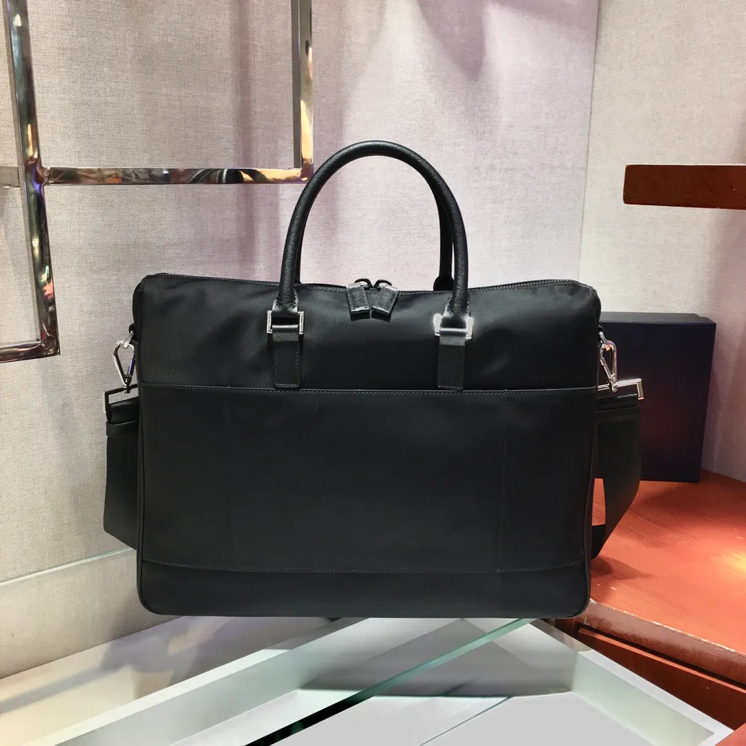 💰1320🎉New Nylon Briefcase🎉2VE017👏👏This nylon briefcase is decorated with Saffiano leather trim and metal hardware, and comes with two handles and two front pockets with side release buttons. Detachable shoulder strap for added functionality. The back pocket can be placed on the trolley case, it is very functional😘Large space capacity👏, it is no problem to carry it on business trips or daily life🙊🙊If you must be fashionable and elegant, men should buy it now👏👏 Length 40x Height 32x Bottom 7cm👏👏👏💰💰💰