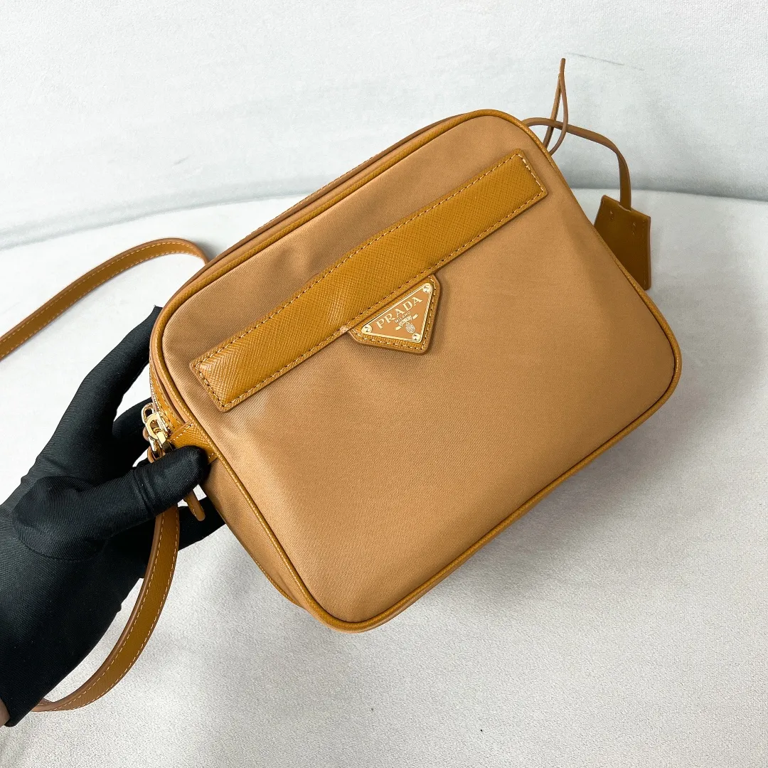 💰1160✨New product debut✨2024Summer new product Re-Edition1978 mini shoulder bag 1BH218 New design mini shoulder bag Made of imported nylon fabric➕Saffiano cowhide trim Elegant and simple bag design Classic logo gold triangle logo on the front Equipped with full leather adjustable long shoulder strap Double zipper closure Equipped with two space compartments➕zipper patch pocket and mobile phone patch pocket Meets exquisite storage needs, perfect details comparable to brick cabinets Super 5🌟 Size: 21*17*8cm