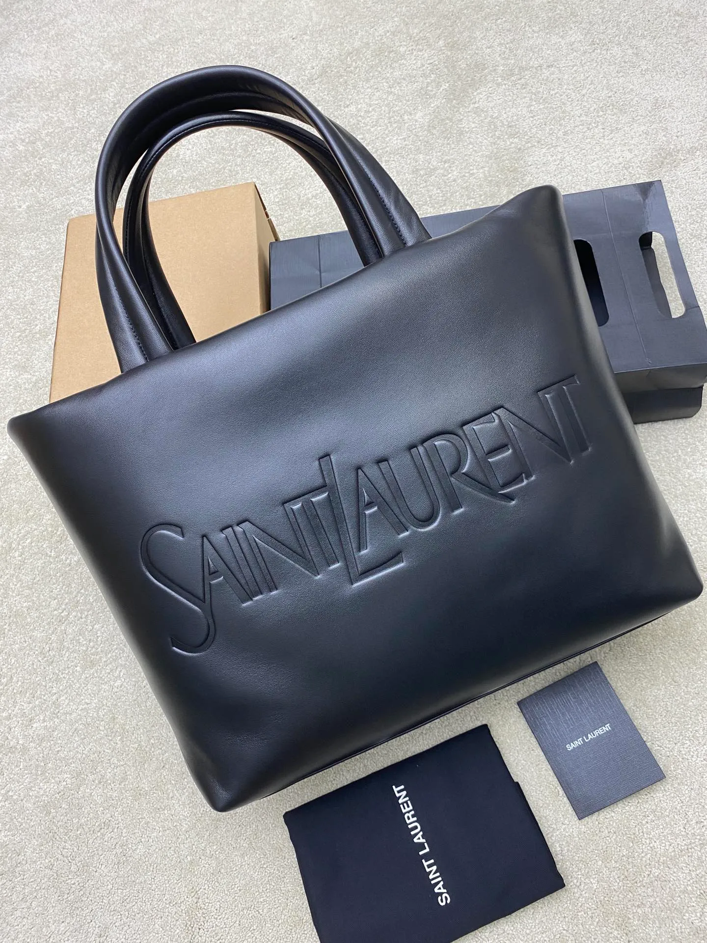 💰2400 black sheepskin/gun 🌈YSL new nappa lambskin tote bag ~ super cool dream bag! A newly launched simple and fashionable shopping tote bag. The letter design is embossed on the front, giving it a handsome and cool look. The inside and outside are full of lambskin texture. It feels super comfortable and is very light. It has a zipper bag inside, making it easy to wear in daily life. It is very practical and comfortable when traveling! Who doesn’t love big soft bags❤️The simple design and low-key style are not to be missed! 202401200 Model: 376269 [original leather] Size: 41-50x43x17cm [only one size without packaging]
