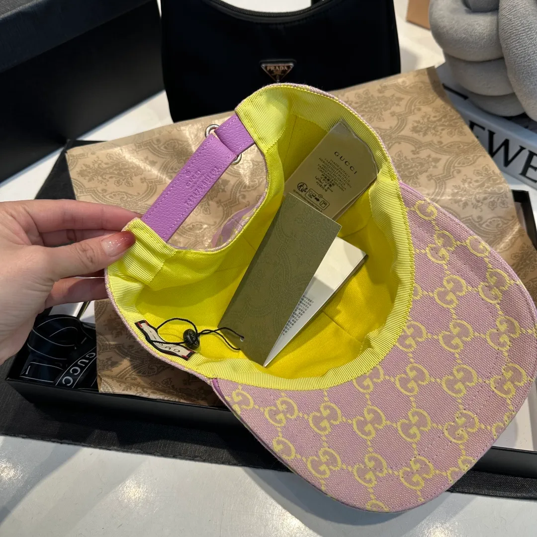 P240 Gucci Baseball Cap🧢Gucci’s classic pattern shines in this fashionable item embellished with the brand’s logo. This baseball cap is crafted from the brand's recognizable GG canvas fabric, with tonal leather details and an adjustable buckle adding to the appeal. Product details ·Pink GG canvas ·Pink leather piping ·Cotton and linen lining ·Adjustable Velcro closure ·70% cotton, 30% polyester; 65% cotton, 35% linen (lining); 55% cotton, 45% viscose (inside); Cow leather (detail); Cow leather (leather piping)