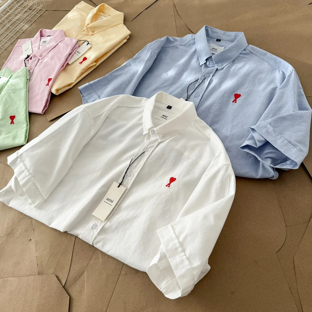 Ami Paris Oxford cotton button-down corner collar casual short-sleeved shirt - small love silhouette style - same style for men and women. Red small love letter embroidery decoration, fashionable and versatile short-sleeved shirt! The counter sells famous French affordable luxury fashion brands at the same time. The classic elements of the brand are popular among celebrities. The basic simple design and fashionable style are must-have couple shirts for men and women!  Made of custom-woven 100% Oxford cloth pure cotton, it feels soft and delicate, has excellent moisture absorption and perspiration performance, and is very comfortable and skin-friendly when worn next to the skin! The chest of the shirt is decorated with the classic love letter A logo embroidery. The top-notch embroidery technology is tight, full and full of details, and is cleverly embellished with bright red. It carries all the eye-catching points. It follows the consistent minimalist French attitude. The fabric is soft and comfortable, suitable for any versatile casual shirt couple!  Color: Blue White Yellow Green Pink Size: S-XL Size: Size Length Bust Shoulder Width Sleeve Length S 73.5 68 56 26.5 M 75.5 70 57 27 L 77.5 72 58 27.5 XL 79.5 74 59 28