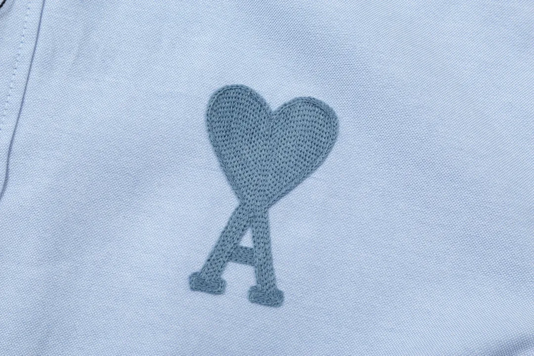 2205# AMI Paris Classic Autumn Towel embroidered with hearts in the same color on the chest Casual cotton solid color long-sleeved Oxford shirt Original customized 180g pure cotton fabric Regular version Same style for men and women Color: White Blue Yellow Aqua Pink Size: S-XL