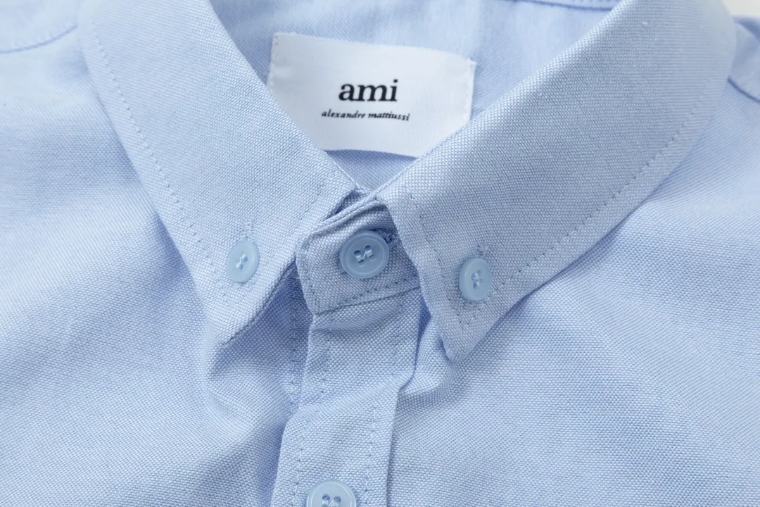 2205# AMI Paris Classic Autumn Towel embroidered with hearts in the same color on the chest Casual cotton solid color long-sleeved Oxford shirt Original customized 180g pure cotton fabric Regular version Same style for men and women Color: White Blue Yellow Aqua Pink Size: S-XL