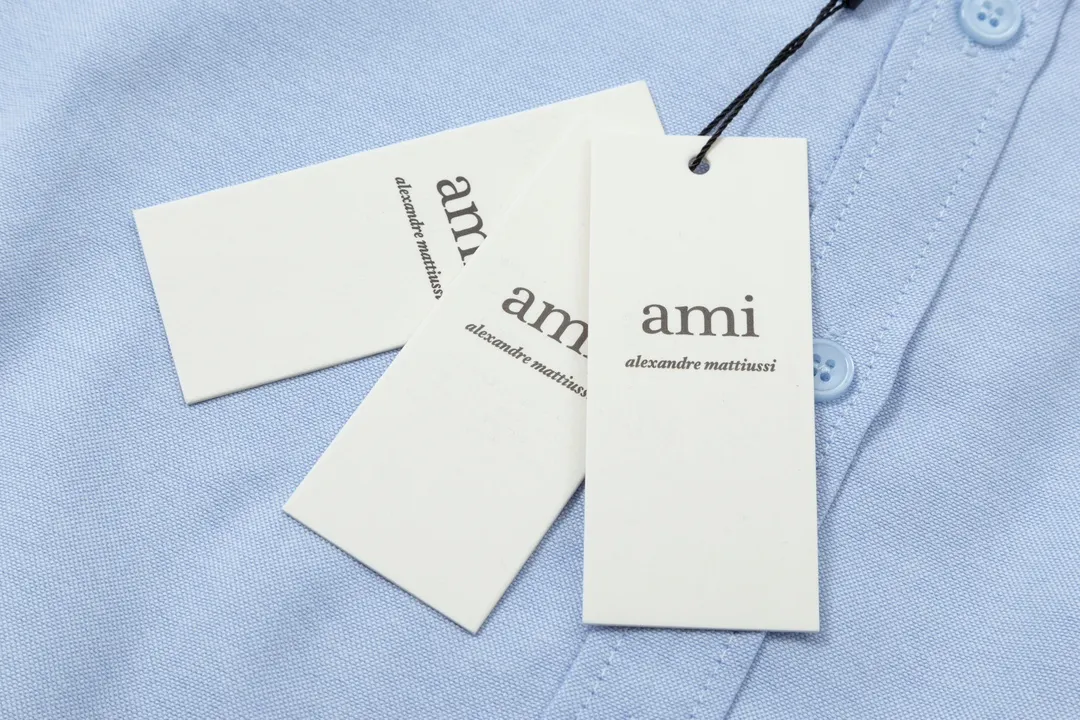 2205# AMI Paris Classic Autumn Towel embroidered with hearts in the same color on the chest Casual cotton solid color long-sleeved Oxford shirt Original customized 180g pure cotton fabric Regular version Same style for men and women Color: White Blue Yellow Aqua Pink Size: S-XL