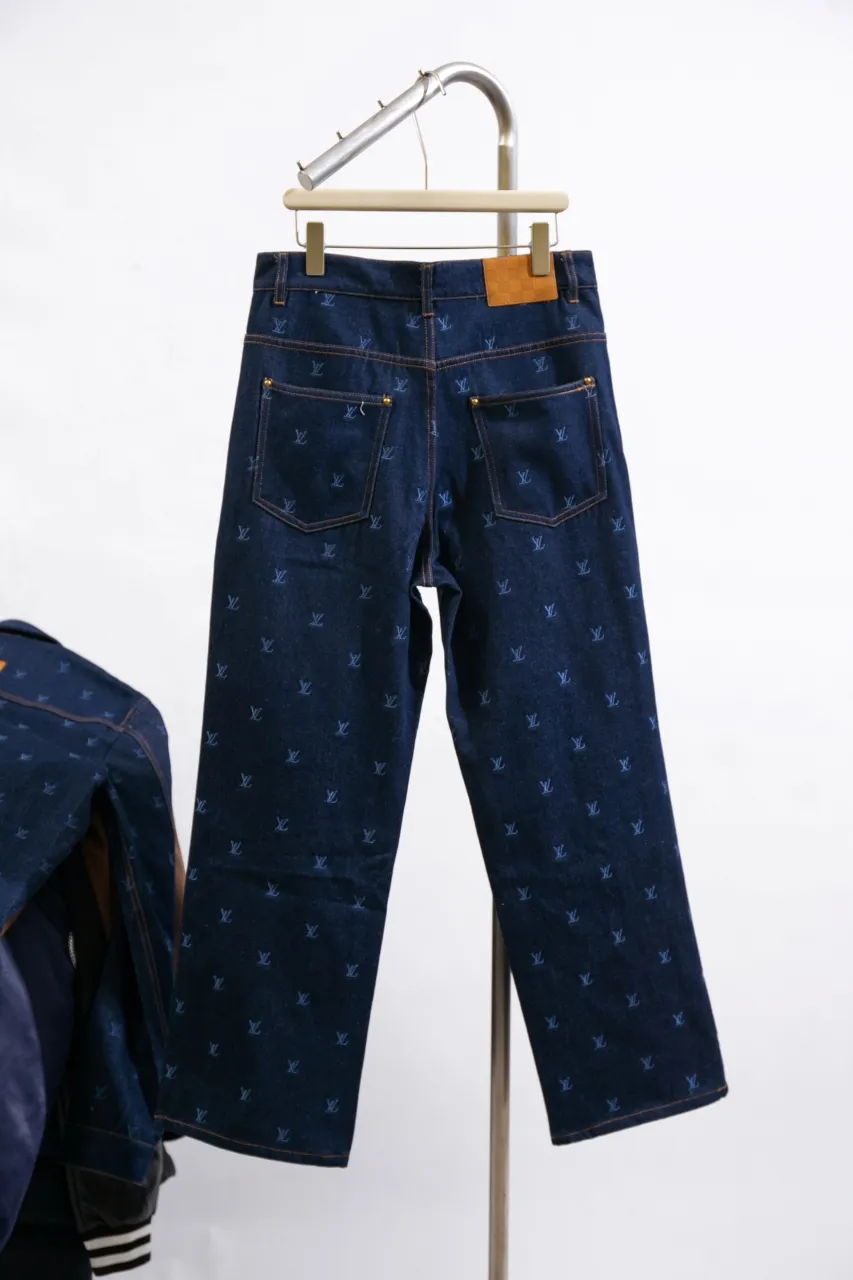 LV Embroidered Jeans This pair of jeans is made of original washed denim, with an all-over LV Blason pattern embroidered with fine yarn. The classic silhouette is finished with a Damier nubuck label and LV metallic accents, making it a sophisticated addition to the matching jacket.  Standard fit All-over LV Blason embroidered Damier nubuck label with LV metallic accents