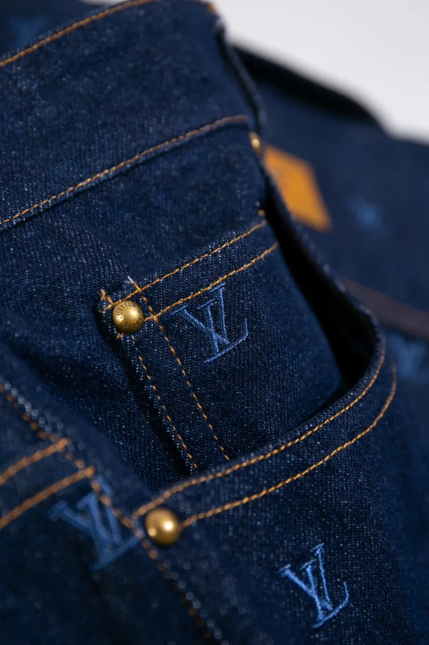 LV Embroidered Jeans This pair of jeans is made of original washed denim, with an all-over LV Blason pattern embroidered with fine yarn. The classic silhouette is finished with a Damier nubuck label and LV metallic accents, making it a sophisticated addition to the matching jacket.  Standard fit All-over LV Blason embroidered Damier nubuck label with LV metallic accents