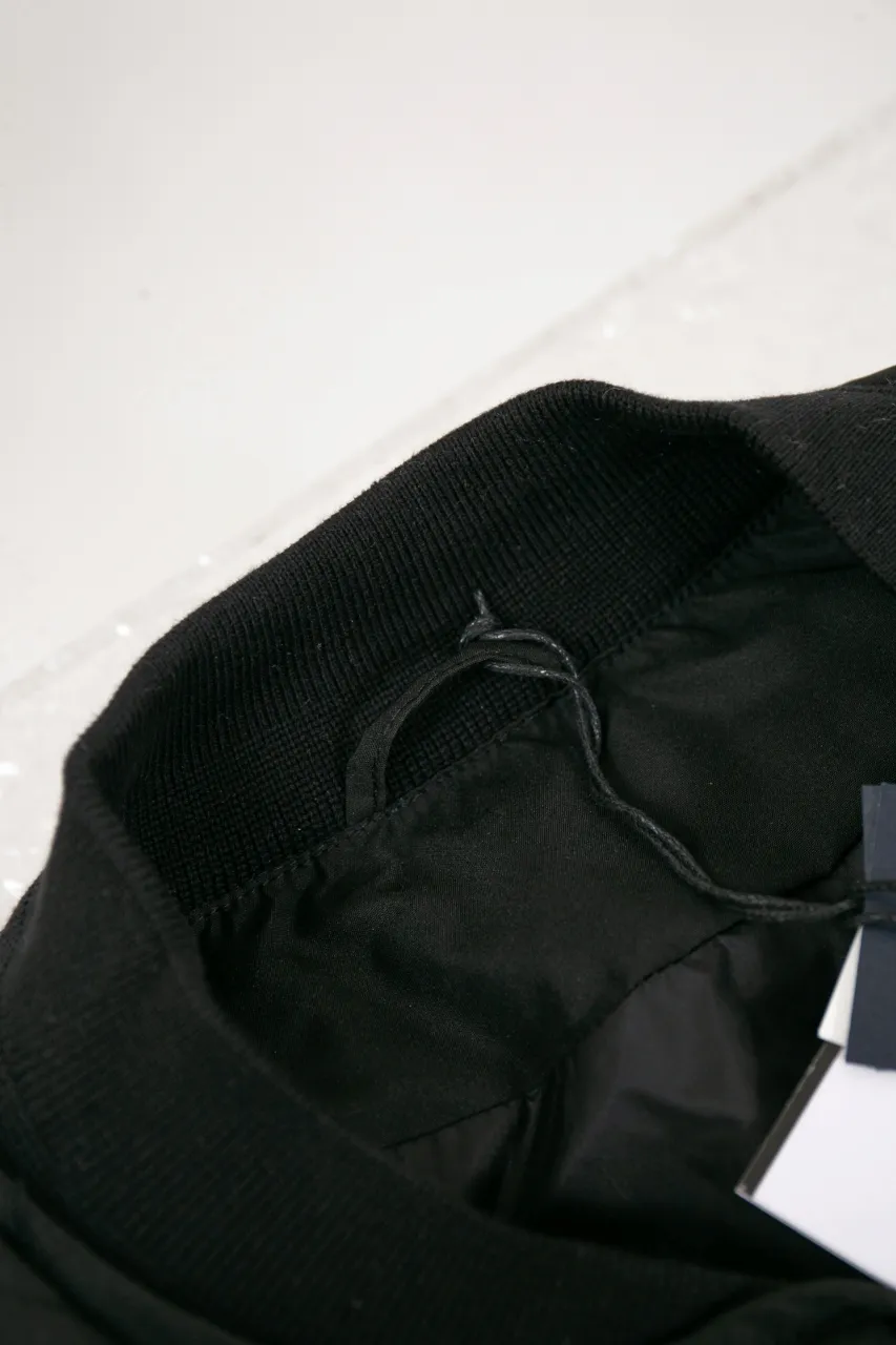 DIOR AND LEWIS HAMILTON JACKET Black technical fabric with removable sleeves This jacket is from the DIOR AND LEWIS HAMILTON limited series. Crafted from black technical fabric and embellished with DIOR AND LEWIS HAMILTON embroidery, the graphic design highlights the iconic Dior signature. With detachable sleeves, it can be worn in two different ways. It can be paired with jeans to create a low-key sporty look. DIOR AND LEWIS HAMILTON Embroidery and zip Knitted collar Detachable sleeves Front and internal flapless pockets Body: 100% nylon, Lining: 100% nylon