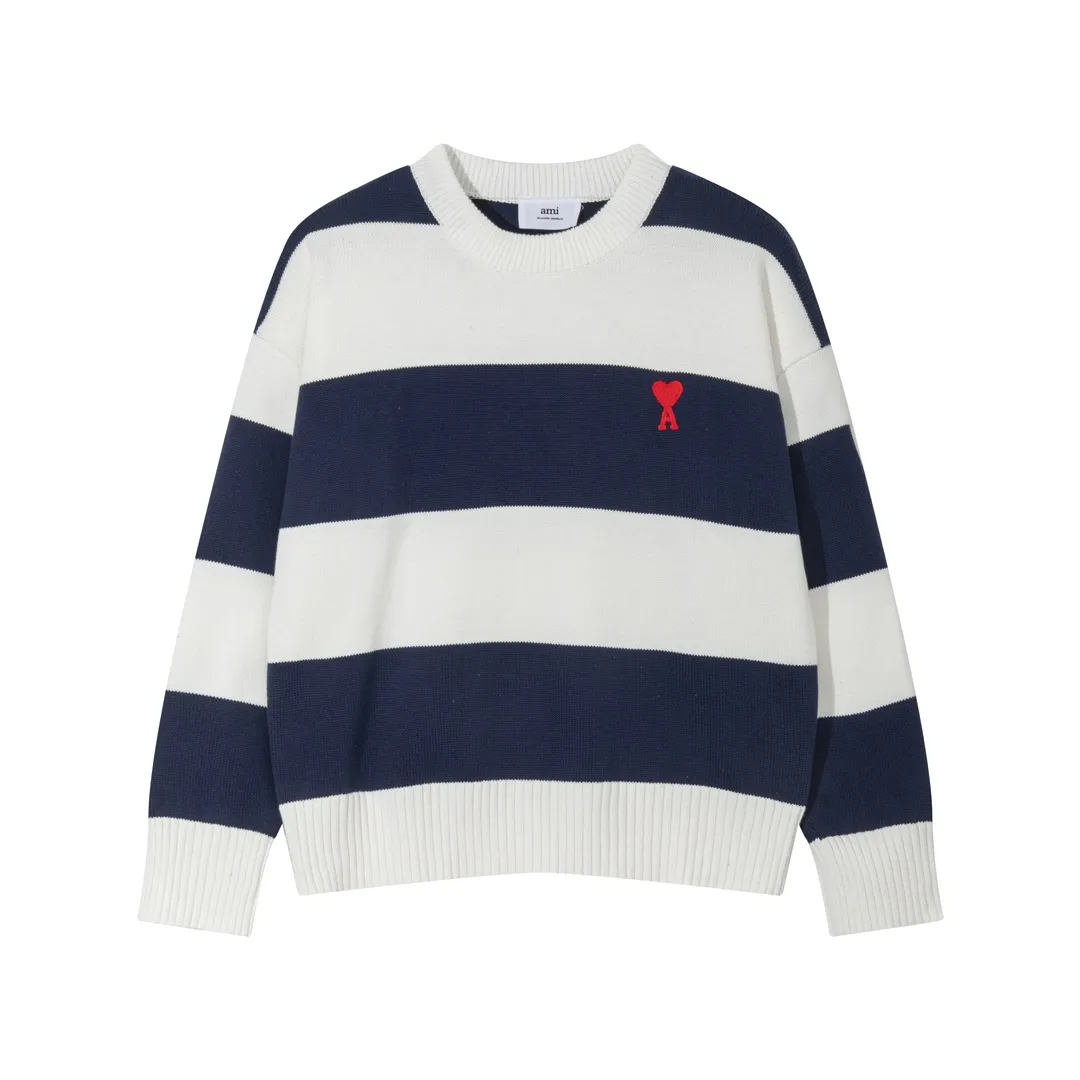P170 A069# AMI Paris2023 new product. Carefully woven with cotton and wool blended yarn. It has dropped shoulder sleeves and a classic round neck. The blue and white striped body is simple and eye-catching. The red embroidery on the chest easily illustrates the brand identity. Same style for men and women. Color: Black and White, Orchid and White. Size: S-XL.