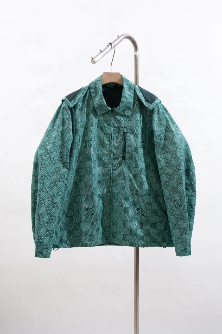 LV Printed Nylon Hooded Windproof Jacket This technical hooded windbreaker combines functional details with the season's nautical theme, sublimating the trend with an all-over Damier Monogram pattern, incorporating micro Monogram details and the Marque L.Vuitton Déposée logo. Fresh colors complete the casual design.  SMLXL