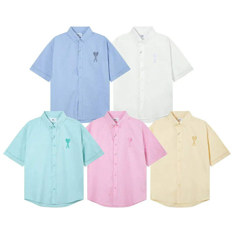 AMI Paris classic autumn heart embroidery in the same color on the chest. Casual cotton solid color short-sleeved Oxford shirt. Original custom-made 180g pure cotton fabric. Loose off-shoulder version. Same style for men and women. Color: Tianlan, white, green, pink, yellow, size: S-XL