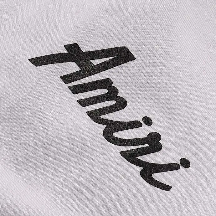 P114 Fabric: 260g double yarn, AMIRI 2025 new spring and summer new logo round neck T-shirt, high street, same style for men and women, loose classic letter foam short sleeves. Color: black. White Size: S M L XL