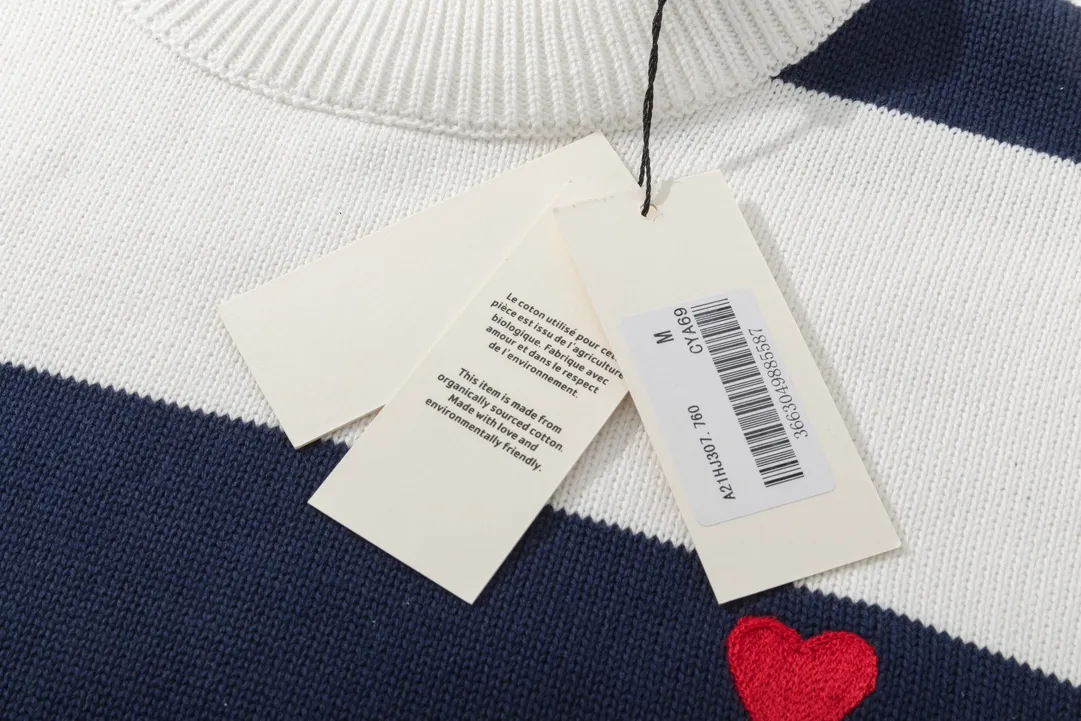 A069# AMI Paris2023 new product. Carefully woven with cotton and wool blended yarn. It has dropped shoulder sleeves and a classic round neck. The blue and white striped body is simple and eye-catching. The red embroidery on the chest easily illustrates the brand identity. Same style for men and women. Color: black and white, orchid white. Size: S-XL