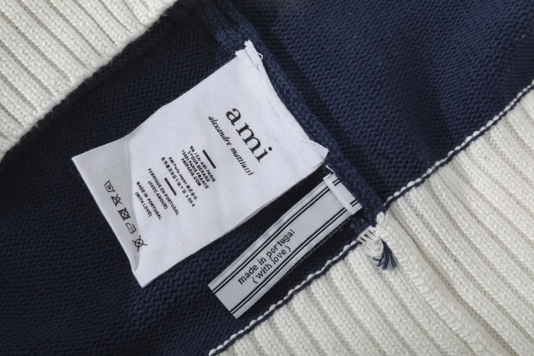 A069# AMI Paris2023 new product. Carefully woven with cotton and wool blended yarn. It has dropped shoulder sleeves and a classic round neck. The blue and white striped body is simple and eye-catching. The red embroidery on the chest easily illustrates the brand identity. Same style for men and women. Color: black and white, orchid white. Size: S-XL