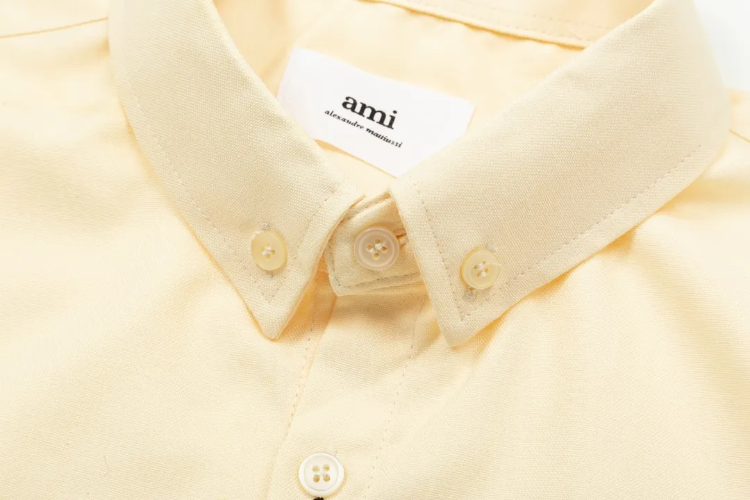 2203# AMI Paris Classic autumn red small love heart embroidery on the chest Casual cotton solid color long-sleeved Oxford shirt Original custom-made 180g pure cotton fabric Regular version Same style for men and women Color: White Blue Yellow Brown Pink Size: S-XL