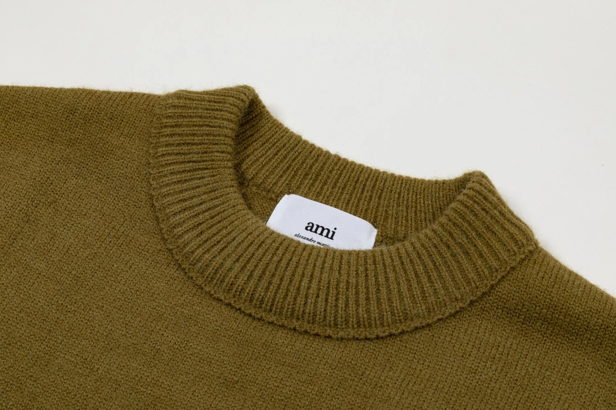 8200# Ami Paris2025 [New product for autumn and winter] Black love jacquard ADC Merino round neck pullover sweater with reverse bone stitching throughout the body. Same style for men and women. Oversize version. Color: white apricot, dark gray, green khaki, size S-XL