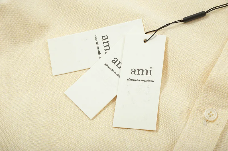 AMI Paris classic autumn heart embroidery in the same color on the chest. Casual cotton solid color short-sleeved Oxford shirt. Original custom-made 180g pure cotton fabric. Loose off-shoulder version. Same style for men and women. Color: Tianlan, white, green, pink, yellow, size: S-XL