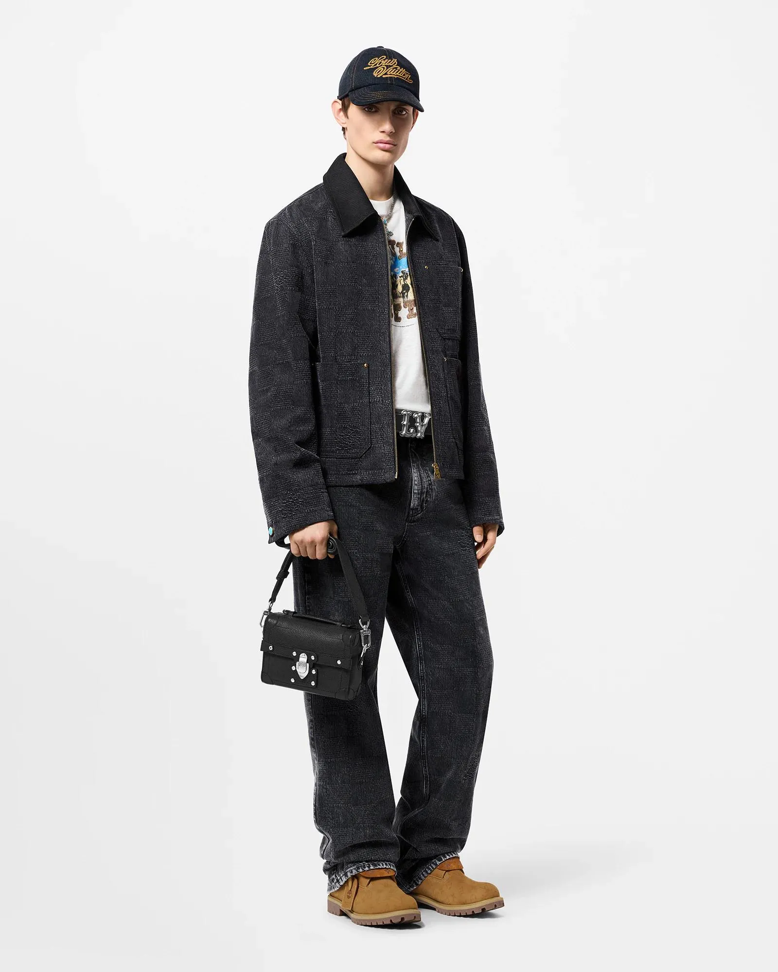 Upper Body Photo LV DAMIER Cotton Work Tunic Jacket This washed denim waist jacket continues the American workwear style of the 2024 autumn and winter show, incorporating the Marque L.Vuitton déposée logo into Damier jacquard canvas. One of the LV Saddle leather patch pockets and nubuck collar with embossed Epi graphic. Buttons add a dandy touch to the cuffs and waist straps, and the unlined design is perfect for different seasons.  Regular fit Marque L.Vuitton déposée logo in Damier jacquard LV Saddle patch on lower left pocket Nubuck collar with Epi embossing Zip front with LV stamped zipper pull Patch pockets Studs Adjustable straps with buttons at cuffs and waist