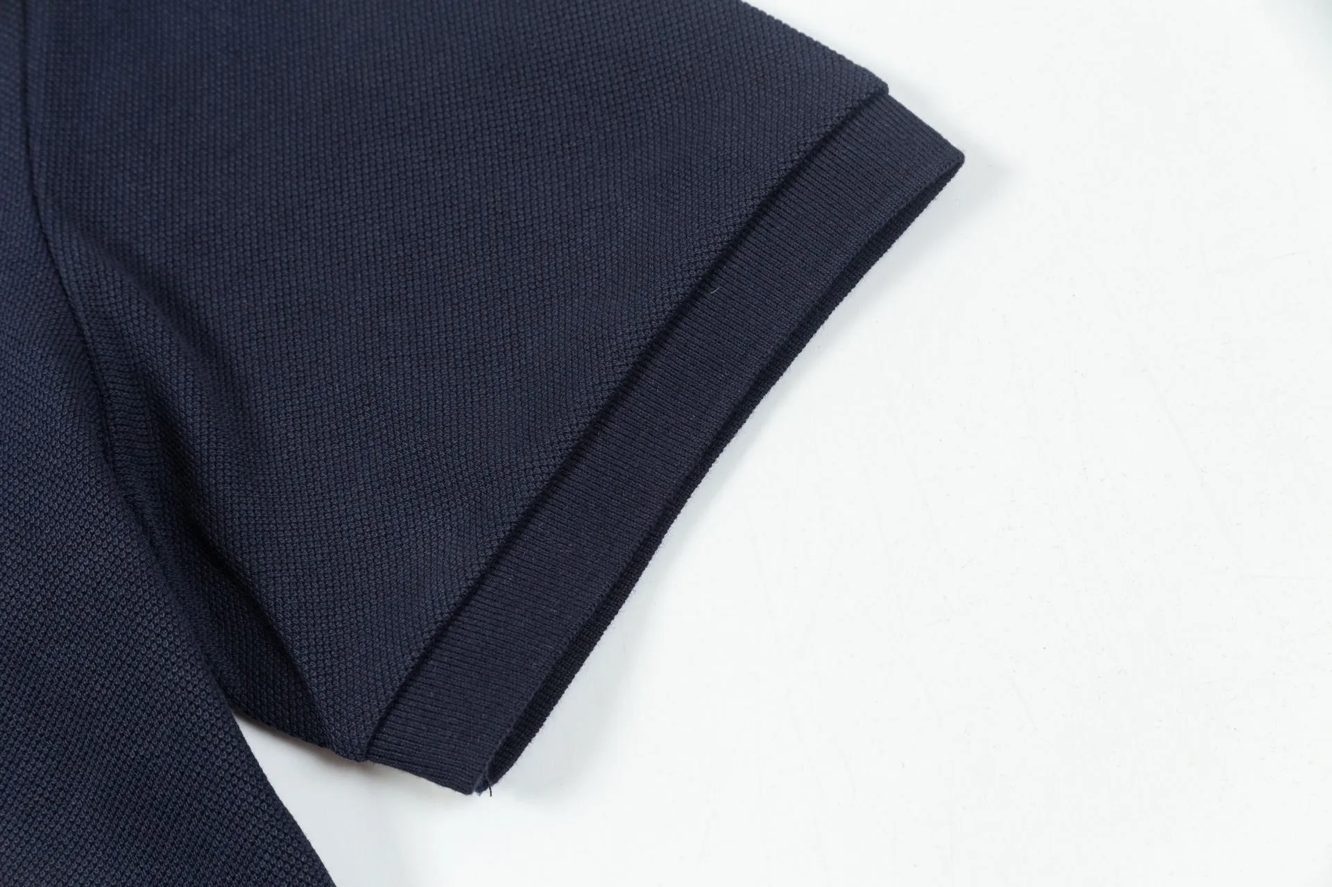 Brand: LV Weight: 270 Color: Blue Black Size: M-XXL Original customization 1:1 restoration Embroidery technology Pure cotton mercerized piqué This polo shirt is made of piqué cotton with a subtle full-width Damier jacquard texture, and the Marque L.Vuitton déposée logo embroidery lights up the sight. Pearlescent buttons add dandy style and can easily be incorporated into everyday looks.  •Regular fit •Damier jacquard pique •Marque L.Vuitton déposée embroidery on chest •Button placket at front •Pearl buttons with LV logo on top button •Ribbed collar and cuffs •100% cotton
