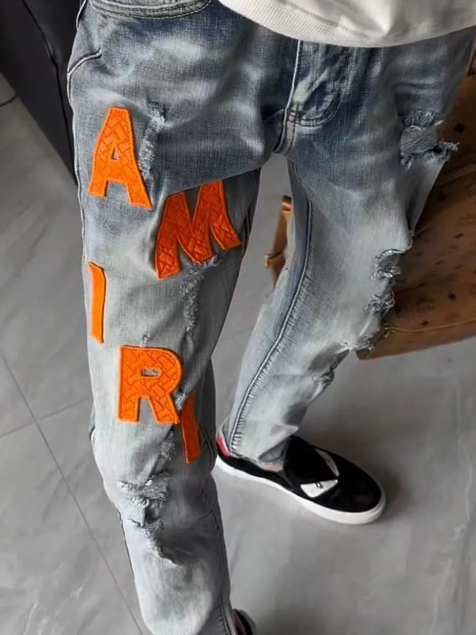 #M38 P168💰 Amiri classic embroidered leather ripped letter jeans slim fit jeans. Produced by a major washed factory. Full of high-end. Knee part destroyed design with patchwork design. Already used as facade design. Leather waist nameplate. The focus of this style is not on washing, but on the destroyed shape and version. The secret lies in the craftsmanship of the master. The cost of post-processing, grinding, cutting, etc. is far beyond the cost of assembly line products. Color: Picture color Size: 30-32-34-36