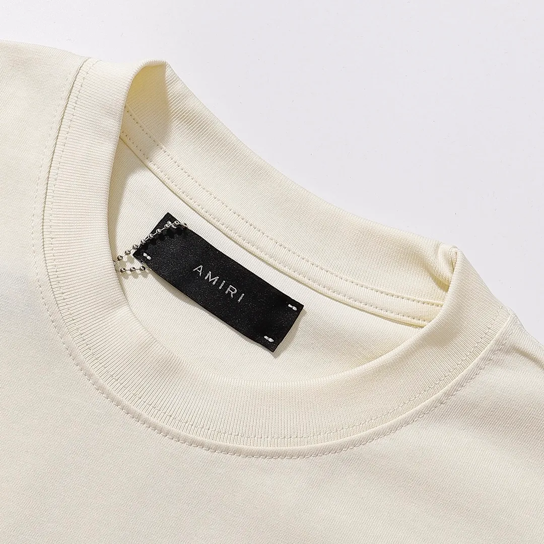 Style number: 749 P114 Fabric: 260g double yarn AMIRI 2025 spring and summer new logo round neck T-shirt high street men and women loose classic letter printed short sleeves Color: black. Apricot Size: S M L XL