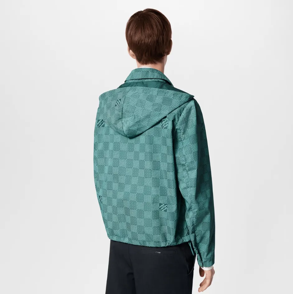 Upper body photo LV printed nylon hooded windproof jacket This technical hooded windproof jacket shows a harmonious blend of functional details and the season's nautical theme. It sublimates the trend style with an all-over Damier Monogram pattern, which is integrated with micro Monogram details and the Marque L.Vuitton Déposée logo. Fresh colors complete the casual design.  SMLXL