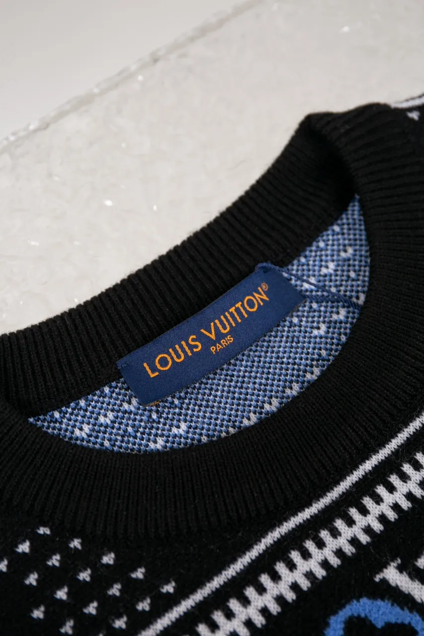 LV Jacquard Sheep Wool Pullover Sweater This pullover is made from responsibly sourced sheep wool. It outlines the classic pattern and the brand's logo jacquard texture on a deep background, and then reinvents the Fair Isle sweater with a soft dropped shoulder design. Wear it over a ski jacket or light up the campfire.  Standard fit All-over LV Fair Isle jacquard with Damier and Monogram details Vuitton logo jacquard in the center