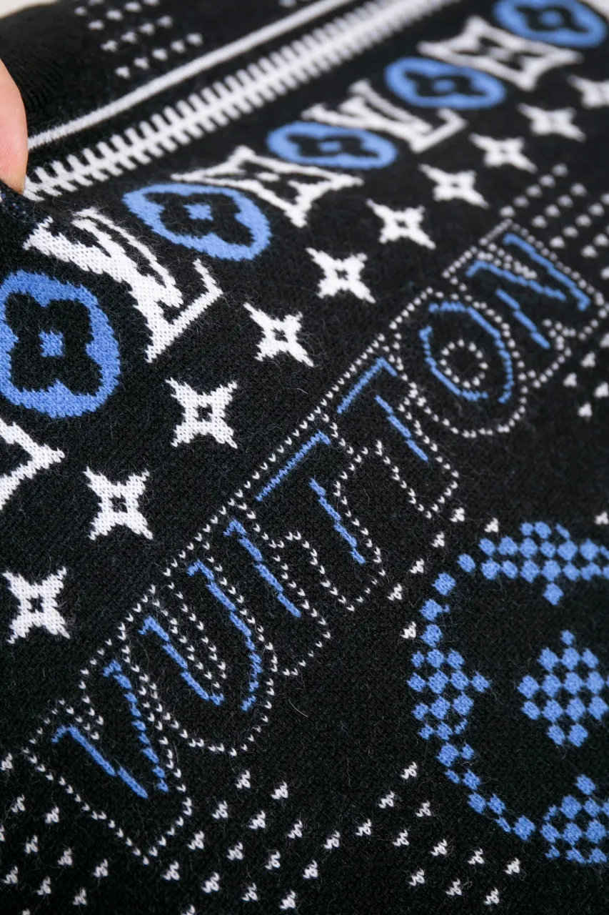 LV Jacquard Sheep Wool Pullover Sweater This pullover is made from responsibly sourced sheep wool. It outlines the classic pattern and the brand's logo jacquard texture on a deep background, and then reinvents the Fair Isle sweater with a soft dropped shoulder design. Wear it over a ski jacket or light up the campfire.  Standard fit All-over LV Fair Isle jacquard with Damier and Monogram details Vuitton logo jacquard in the center