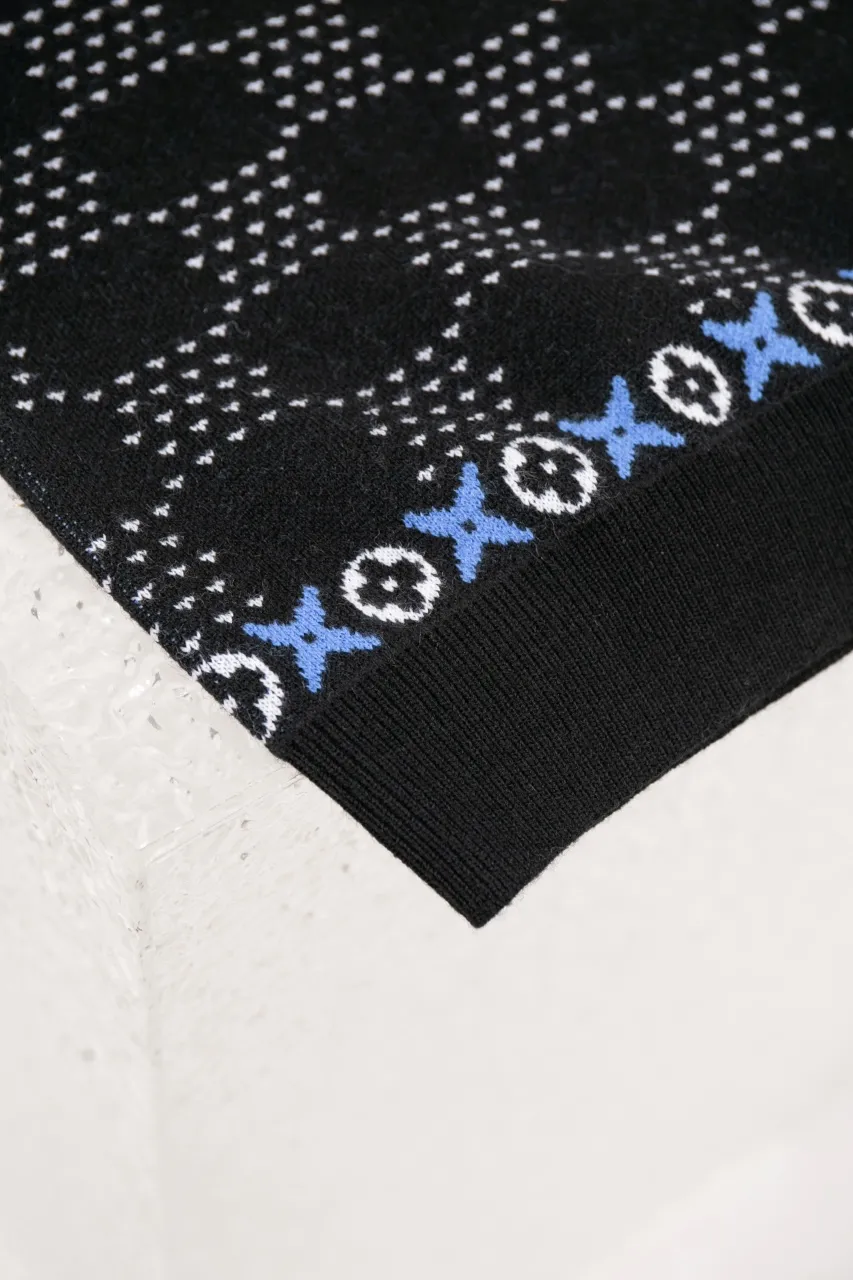 LV Jacquard Sheep Wool Pullover Sweater This pullover is made from responsibly sourced sheep wool. It outlines the classic pattern and the brand's logo jacquard texture on a deep background, and then reinvents the Fair Isle sweater with a soft dropped shoulder design. Wear it over a ski jacket or light up the campfire.  Standard fit All-over LV Fair Isle jacquard with Damier and Monogram details Vuitton logo jacquard in the center